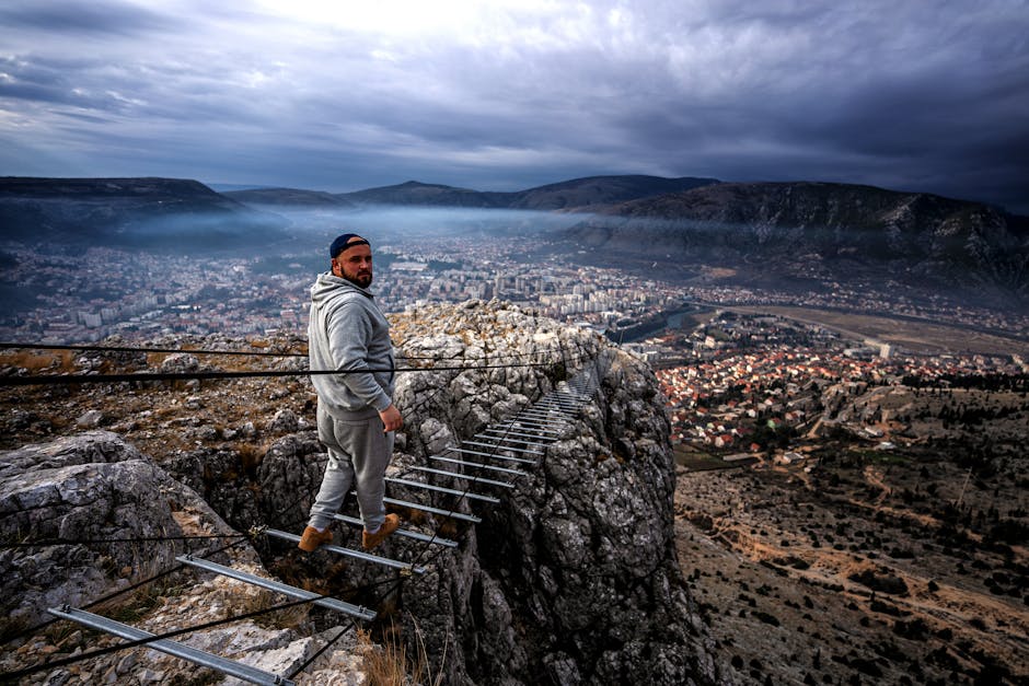 A man looks back while walking on a narrow mountain trail above Mostar, Bosnia.